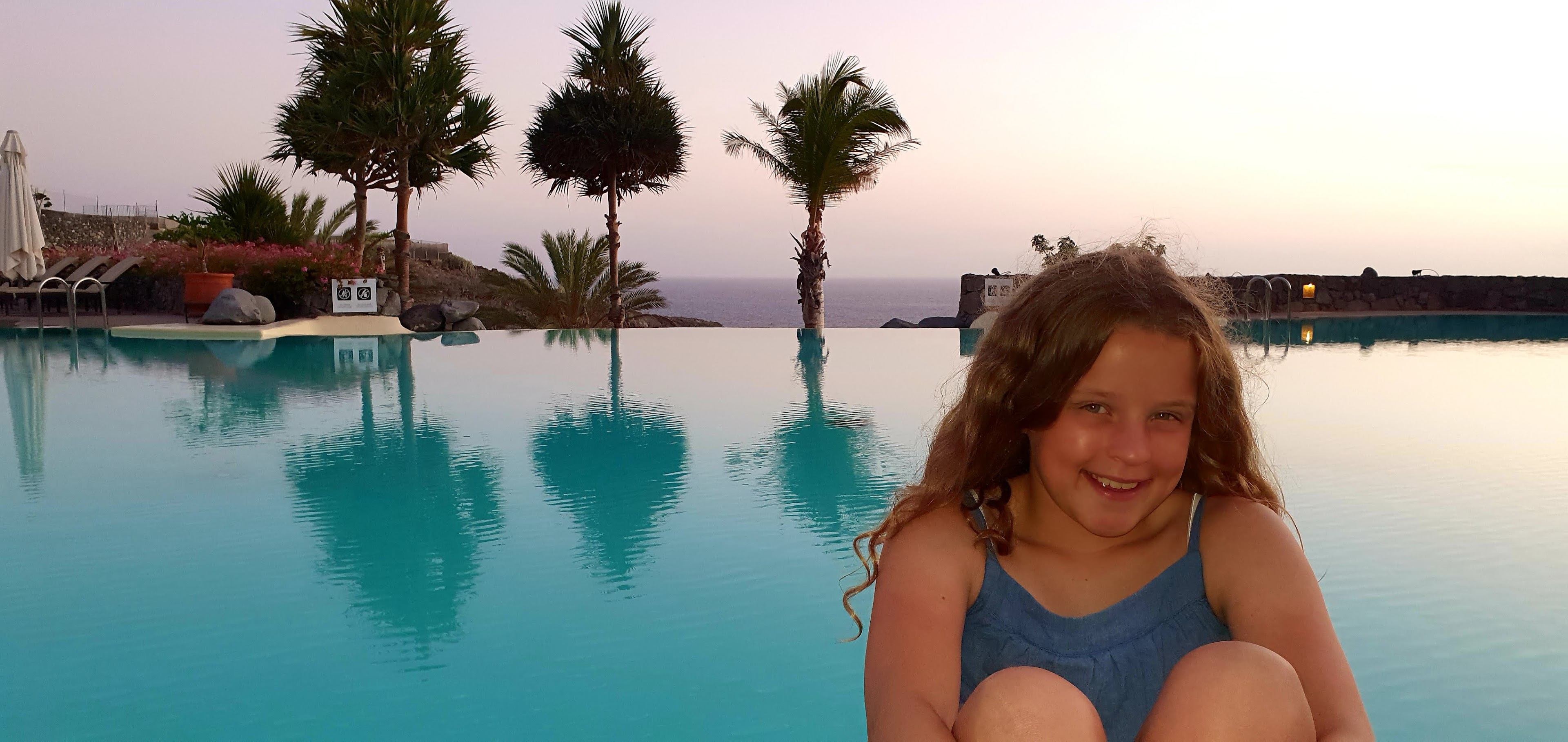Eibhlin smiling beside a still pool at dusk